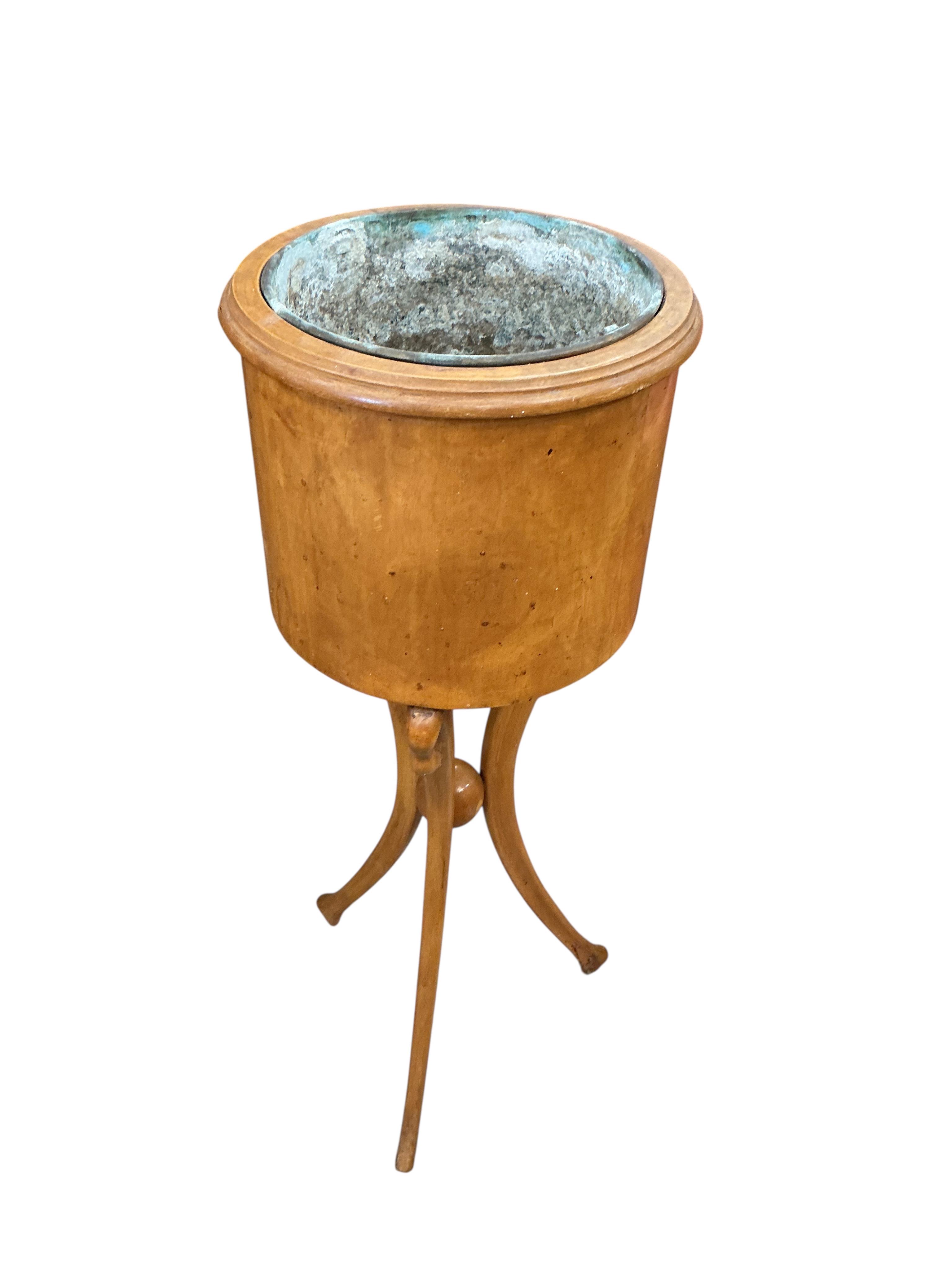 A pair of Empire style circular mahogany jardinieres with swan neck tripod bases, height 83cm